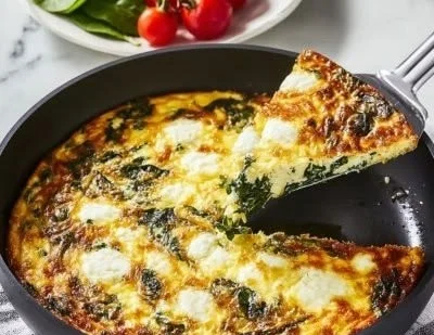 Savory spinach frittata with goat cheese and sun-dried tomatoes on a plate