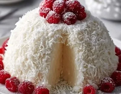 Homemade Snowball Cake with whipped cream and coconut topping