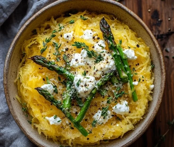 Spaghetti squash dish topped with asparagus, ricotta cheese, lemon zest, and thyme.
