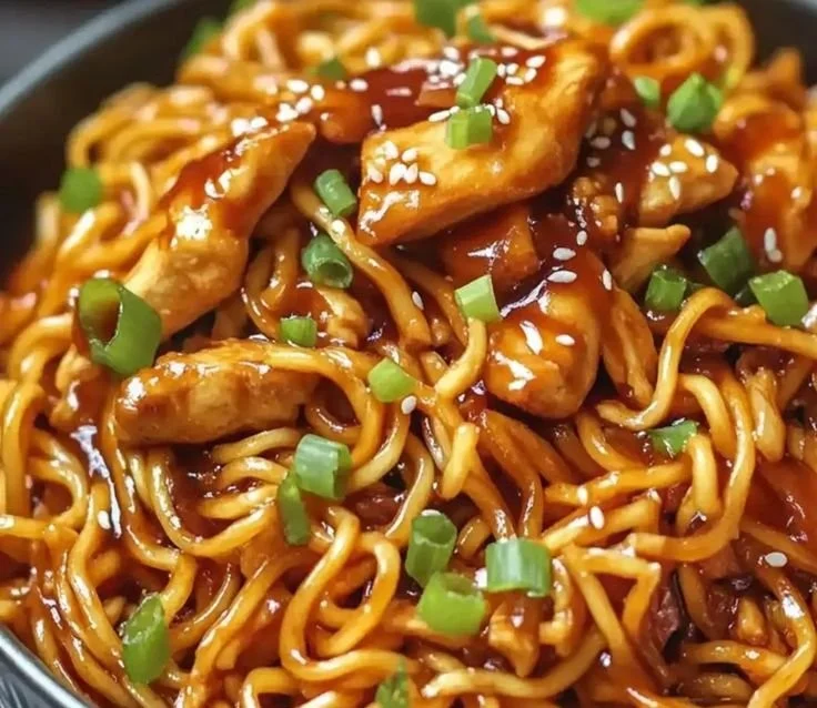 Delicious sticky garlic chicken noodles served in a bowl