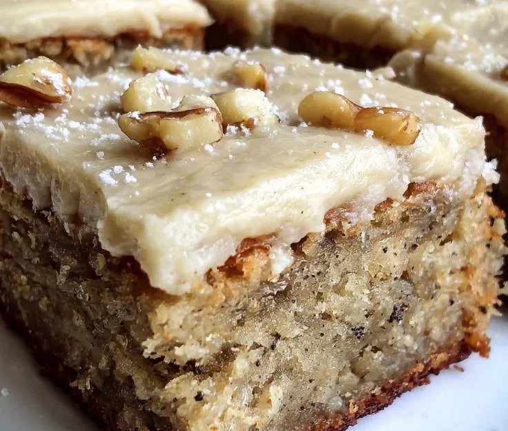 Delicious banana bread brownies with brown butter frosting on a plate