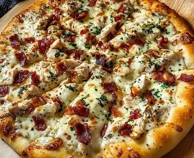 Delicious homemade chicken bacon ranch pizza topped with cheese and herbs