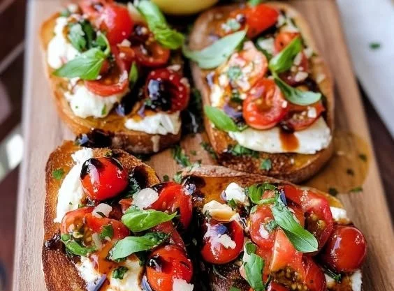 Burrata bruschetta toasts with tomatoes and basil on a rustic platter.