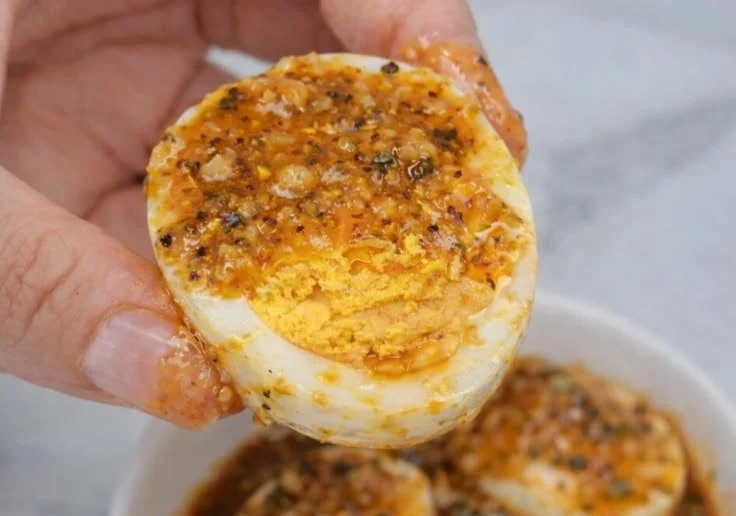 Delicious Cajun Crab dish served with boiled eggs, showcasing vibrant flavors.