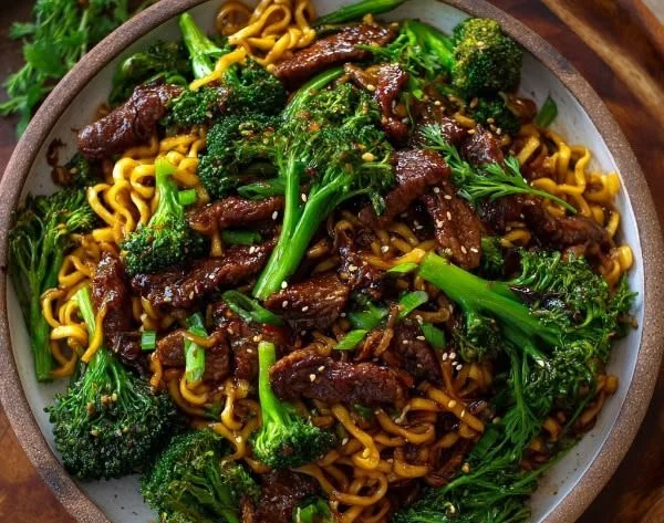 Chinese crispy beef served with broccoli and noodles in a delicious bowl
