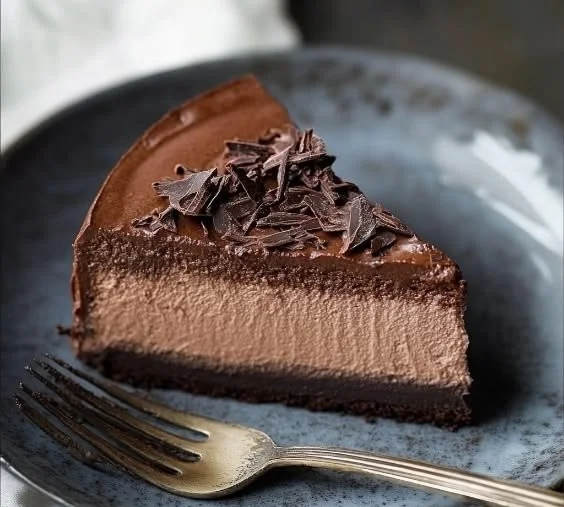 Deliciously crafted Chocolate Mousse Cake topped with chocolate shavings.