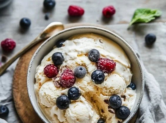 A bowl of homemade cottage cheese ice cream topped with fresh fruits
