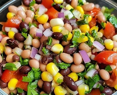 Colorful bowl of Cowboy Caviar featuring beans, corn, and peppers.