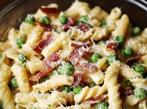 Creamy Pea and Bacon Pasta Salad served in a bowl with fresh ingredients