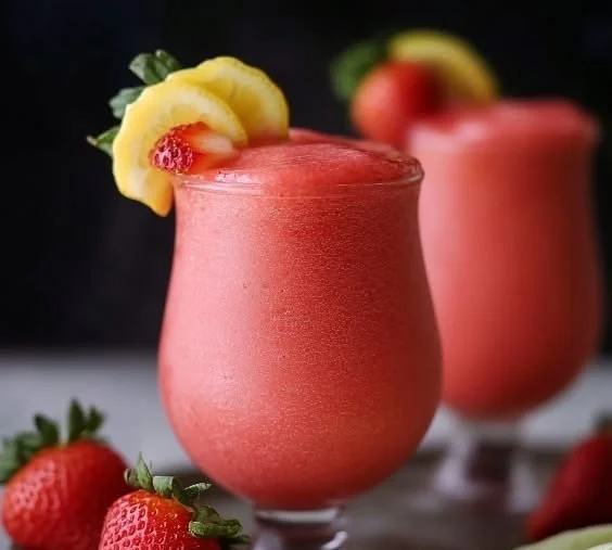 Refreshing easy frozen strawberry lemonade in a glass with ice and strawberries