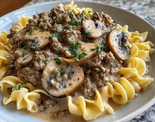 Delicious Ground Beef Stroganoff served with egg noodles and garnished with parsley