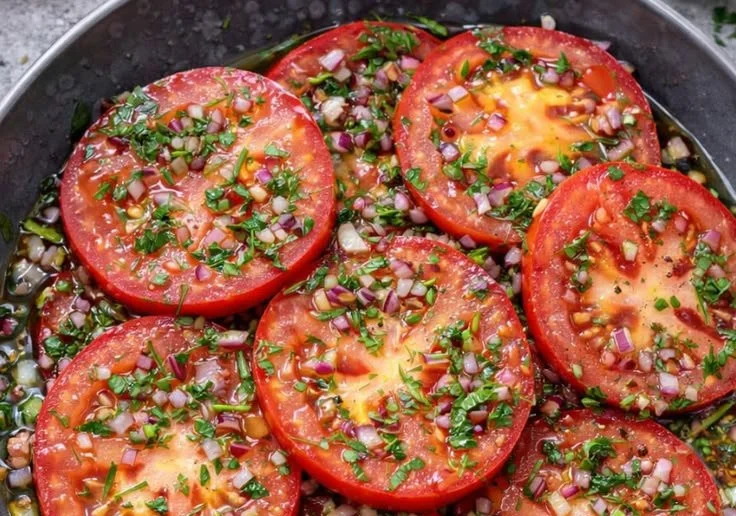 Delicious marinated tomato salad with fresh herbs and spices