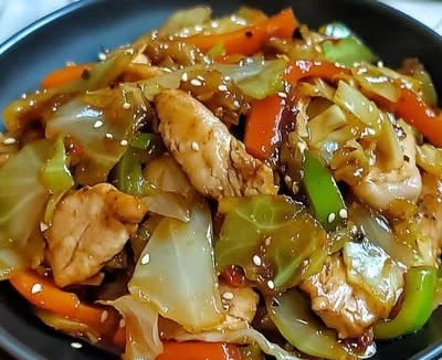 Delicious Chicken Cabbage Stir-Fry cooked in a pan with colorful veggies.