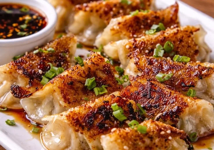Homemade Pork Potstickers served with dipping sauce on a plate