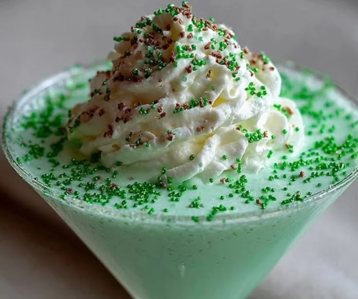 Shamrock Shake Martini - creamy mint cocktail in a glass with festive decorations