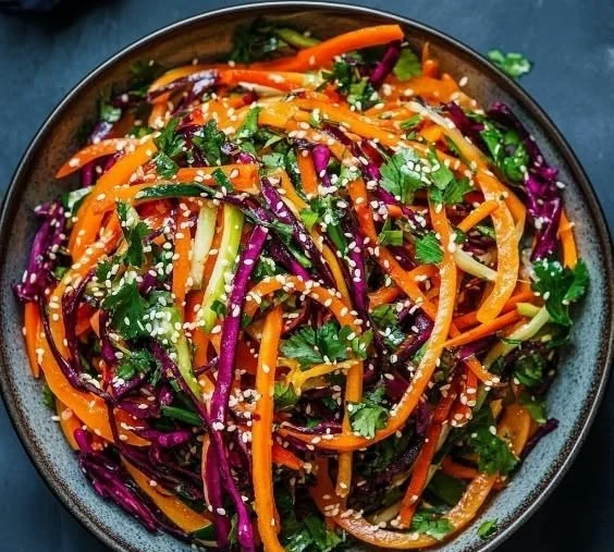 Colorful Rainbow Carrot Salad with sesame dressing and shaved carrots.