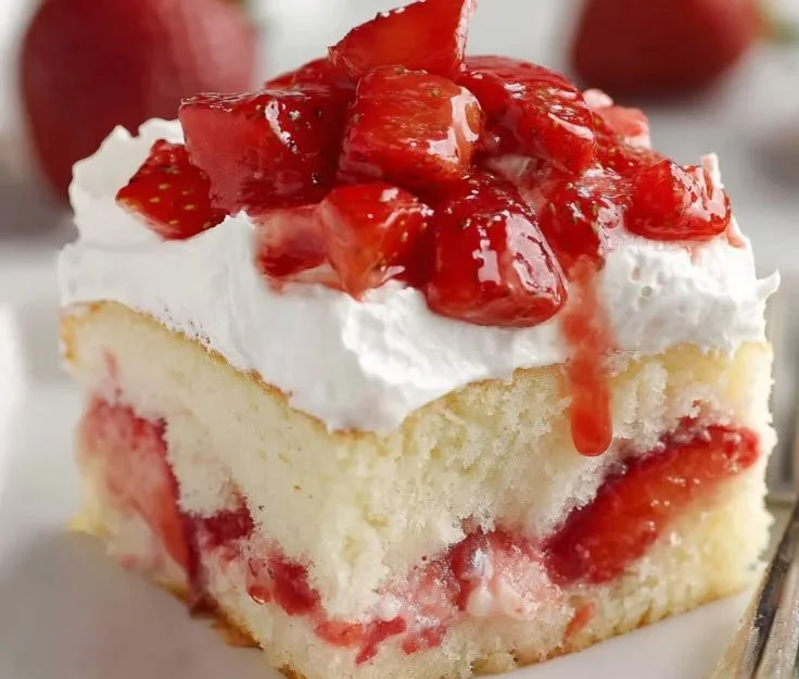Delicious homemade Strawberry Shortcake Sheet Cake topped with fresh strawberries.