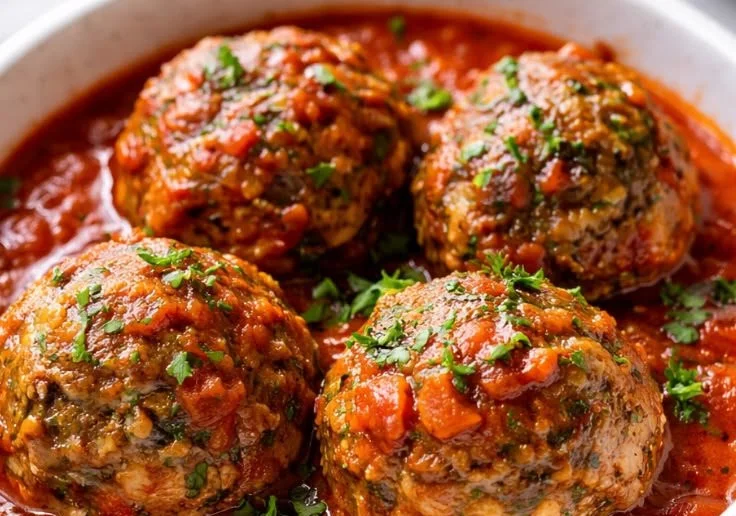 Delicious tender Italian Beef Meatballs served with marinara sauce and herbs.