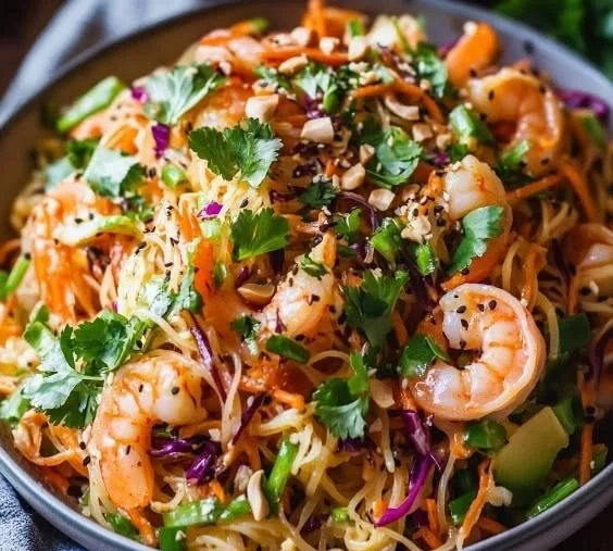 A vibrant plate of Thai Noodle Salad with Shrimp, filled with colorful vegetables.