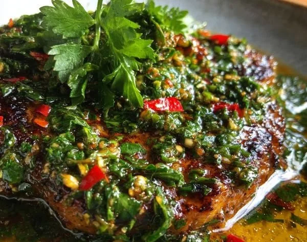 Zesty Argentinian Chimichurri Sauce drizzled over grilled meat
