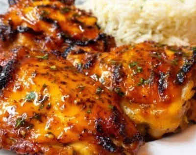 Baked peri peri chicken served with a side of spicy dipping sauce