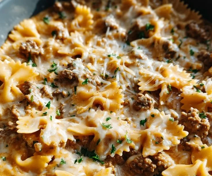 Beef and bowtie pasta in garlic butter served in a bowl