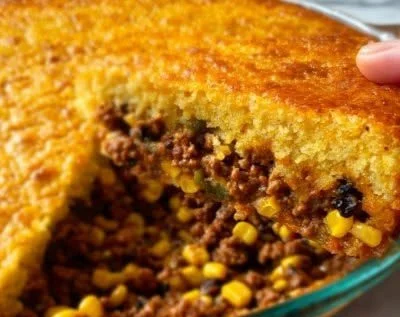 Delicious Cowboy Cornbread Casserole topped with cheese and green onions