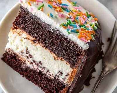 Homemade ice cream cake with chocolate and vanilla layers garnished with sprinkles.