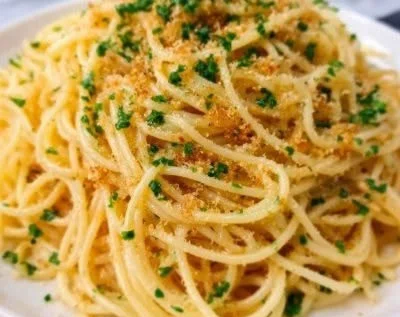 A plate of Lemon Garlic Butter Pasta garnished with fresh herbs.