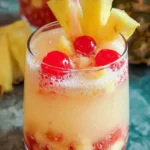 Pina Colada Sangria garnished with tropical fruits in a cheerful glass