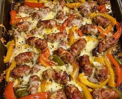 Sheet pan sausage and peppers dish, garnished and ready to serve.