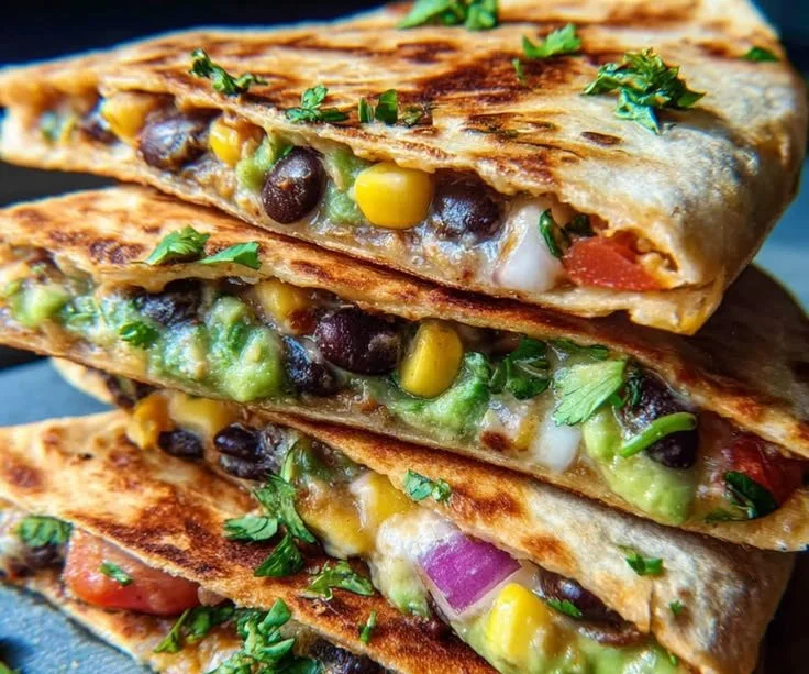 Delicious black bean and avocado quesadillas served on a plate.