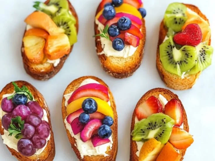 Vibrant Rainbow Crostini with colorful toppings on a wooden board
