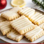 Zesty lemon shortbread cookies with glaze on a plate